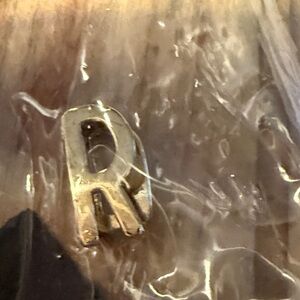 Gold letter “R” keep collective charm